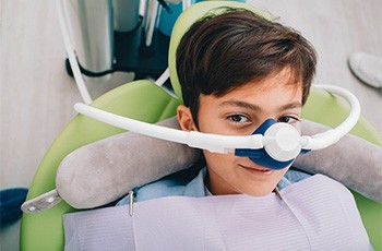 A patient smiling while receiving nitrous oxide sedation