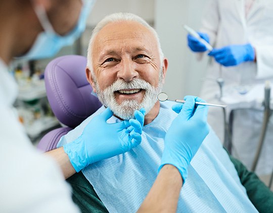 An older man having his teeth checked