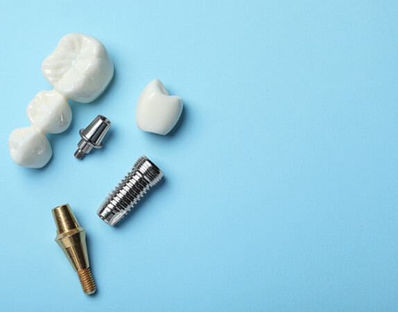 2 dental implants in pieces on a light blue background